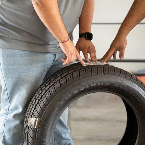 Employee holding tire